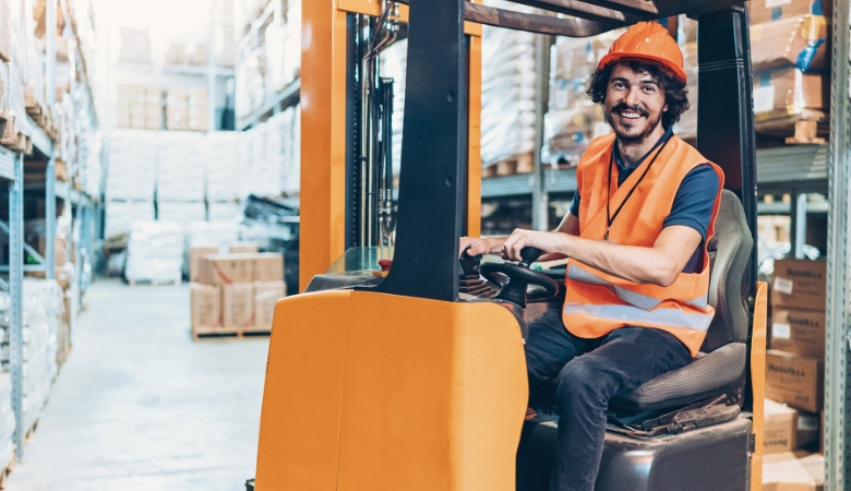 Operação de empilhadeiras onde o operador está trabalhando num setor de logística.
